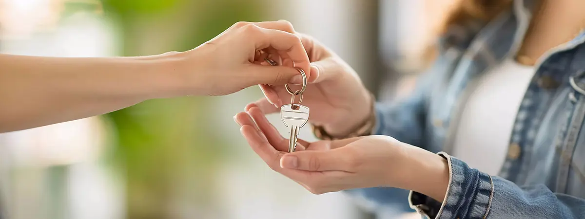 realtor handing keys to homebuyer