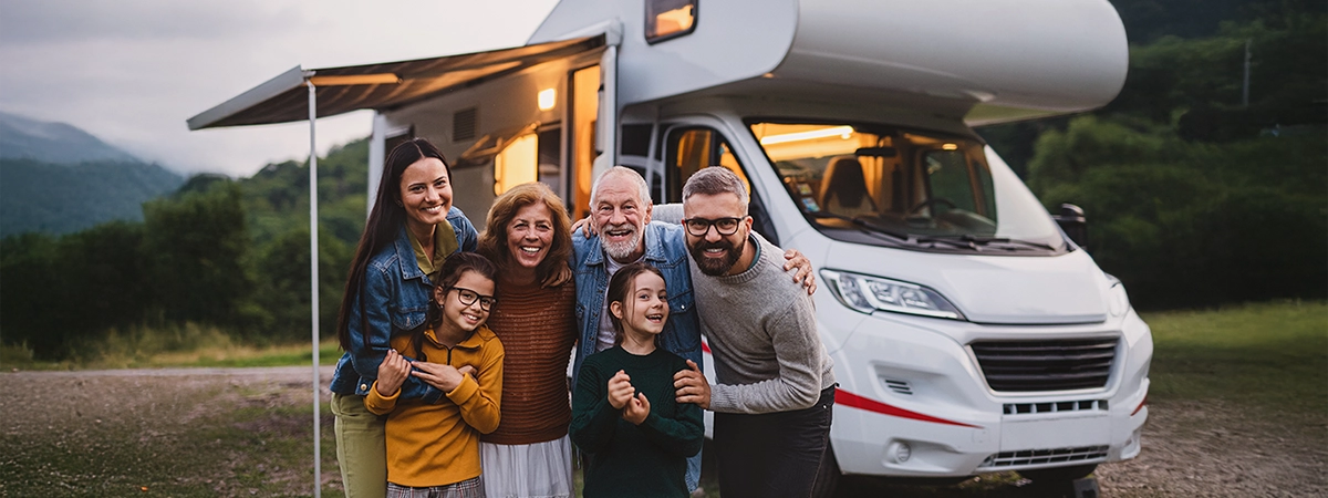 happy family in front of their RV