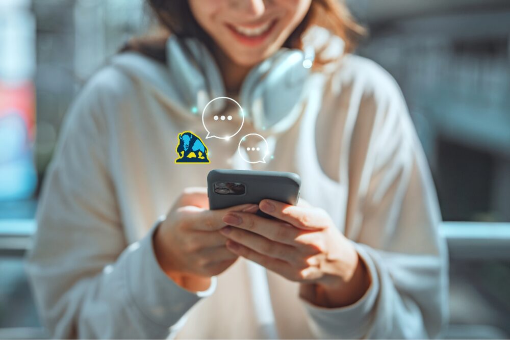 Happy young Asian woman using mobile smartphone with AI chatbot for online information