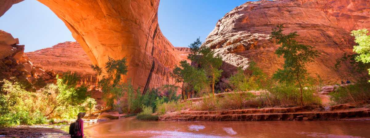 A hiker at Jacob Hamblin Arch in Coyote Gulch, Grand Staircase-Escalante National Monument, Utah, United States